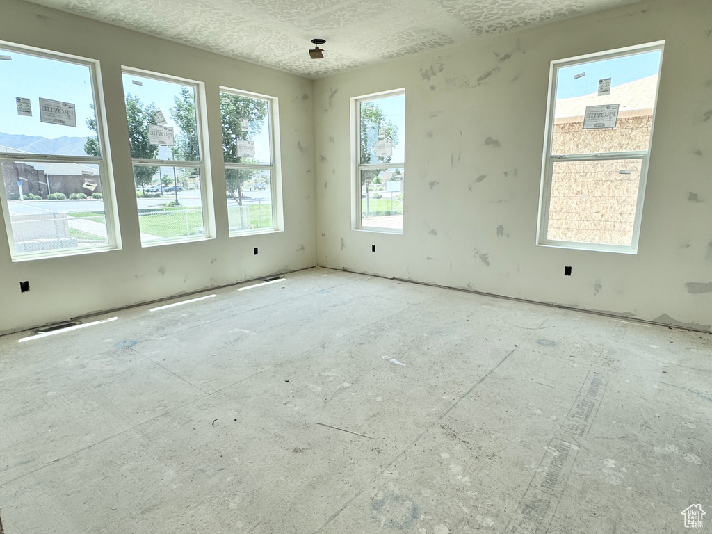 Unfurnished room featuring a textured ceiling