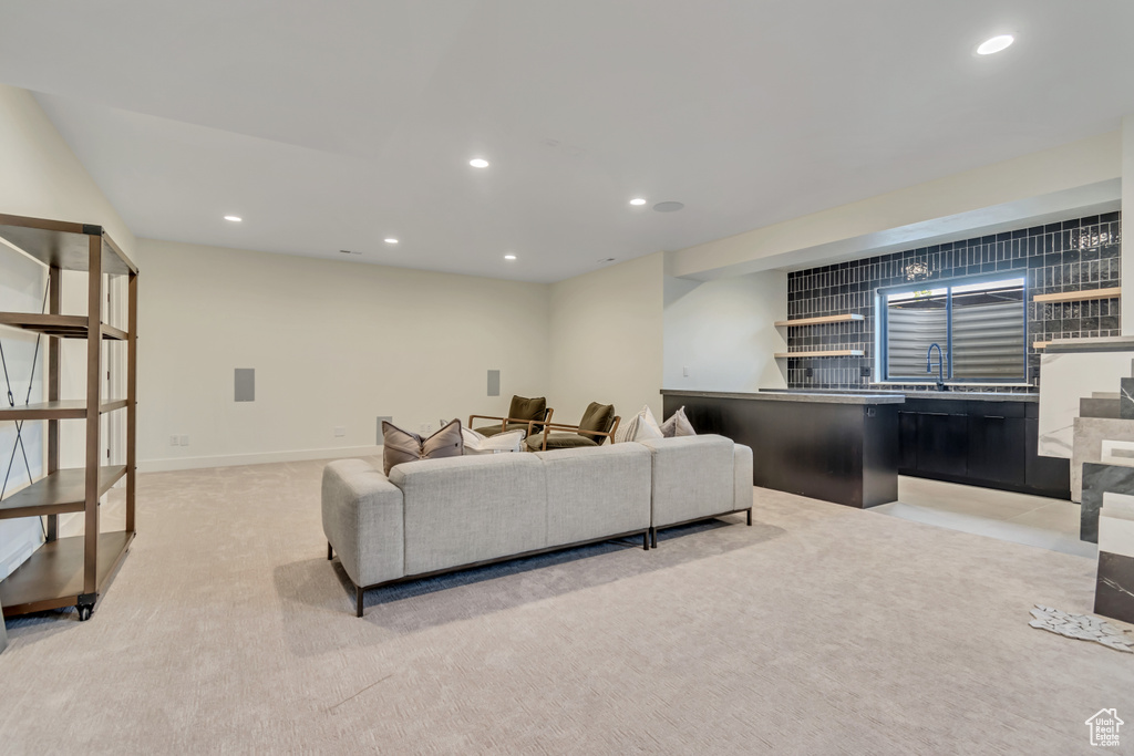 Living area with recessed lighting and light colored carpet