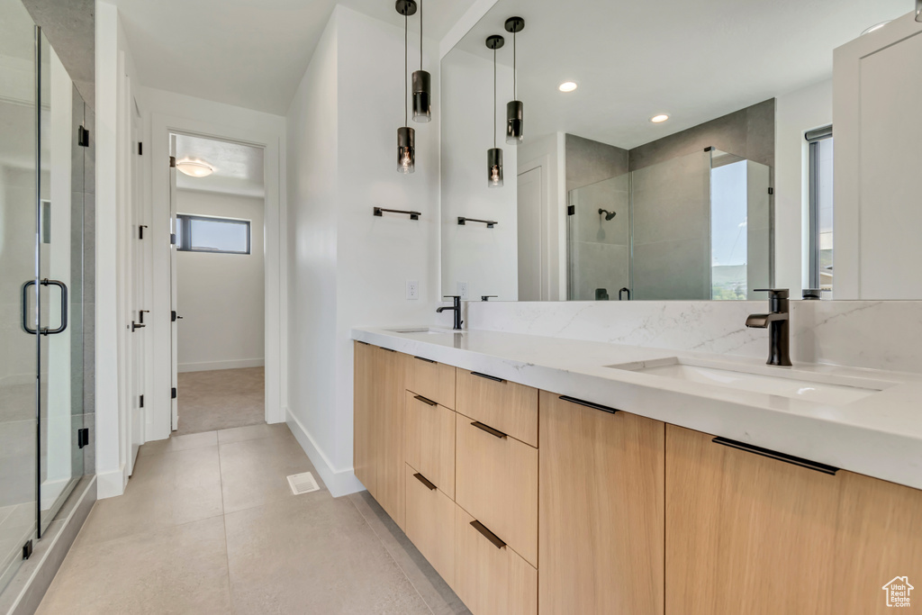 Full bath with a stall shower, double vanity, baseboards, tile patterned flooring, and recessed lighting