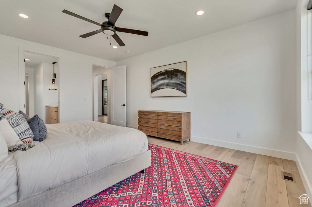 Bedroom featuring light wood-type flooring, recessed lighting, baseboards, ensuite bathroom, and a ceiling fan