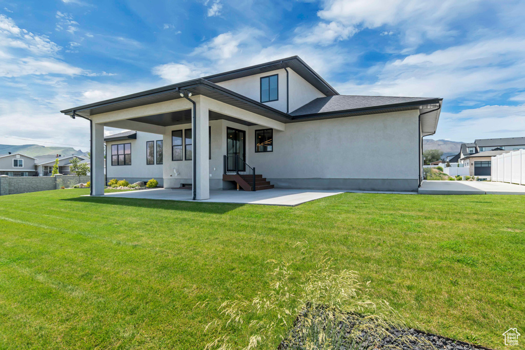Rear view of property featuring stucco siding and a patio