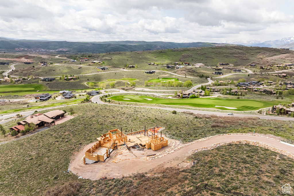 Drone / aerial view of a mountain backdrop and a golf course