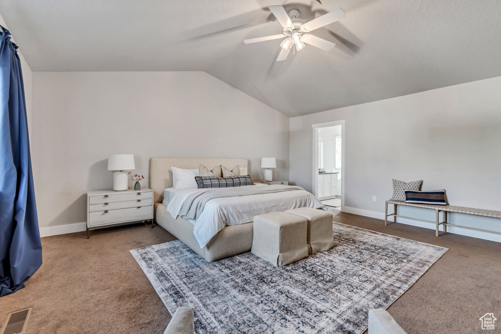 Bedroom with carpet, lofted ceiling, baseboards, a ceiling fan, and ensuite bathroom