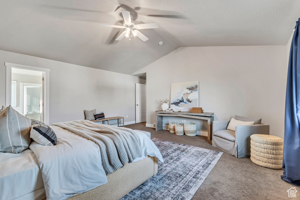 Carpeted bedroom with vaulted ceiling and a ceiling fan