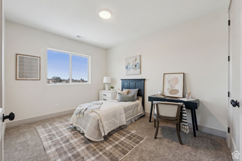 Carpeted bedroom featuring baseboards