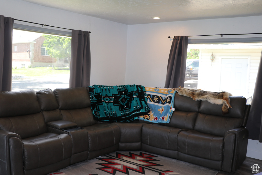 Living area featuring a textured ceiling and recessed lighting