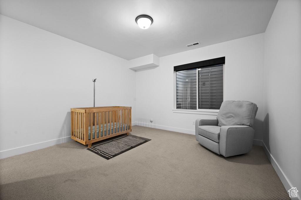 Bedroom featuring carpet and baseboards