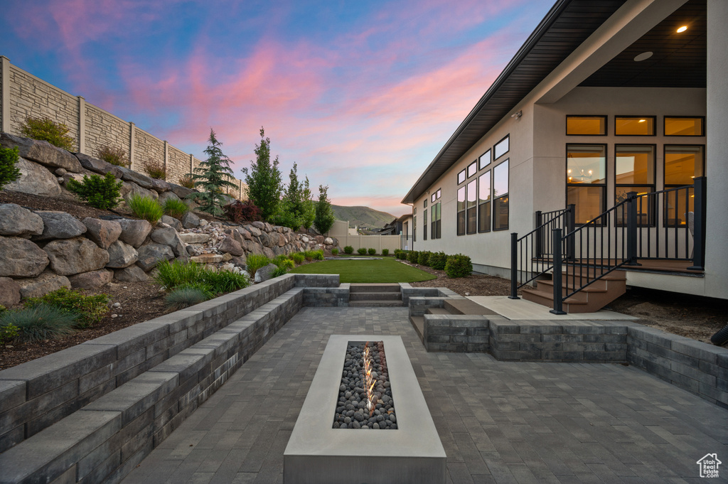 Patio terrace at dusk with a fire pit and a patio