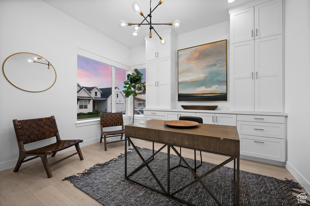 Office featuring a chandelier, baseboards, and light wood-style floors