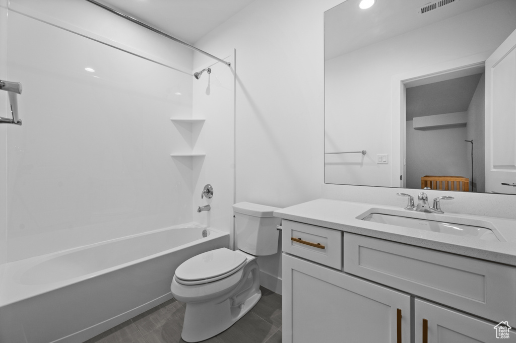 Full bath with toilet, vanity, bathing tub / shower combination, and recessed lighting