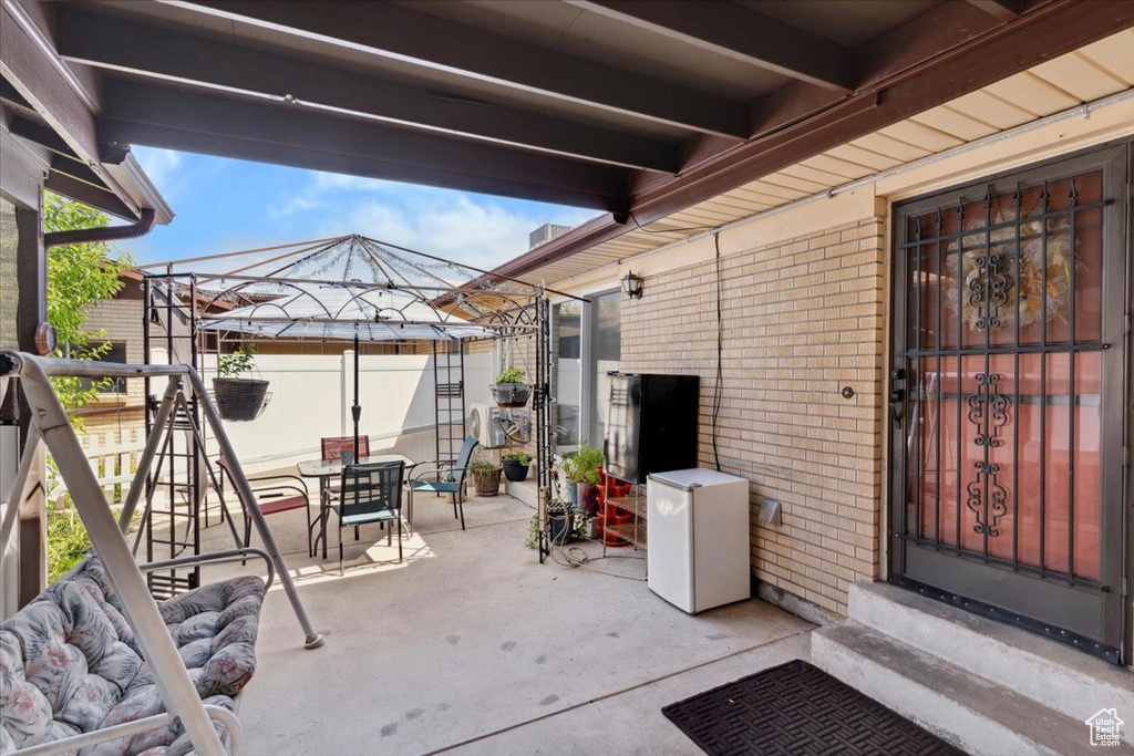 View of patio / terrace with outdoor dining space, a gazebo, and entry steps