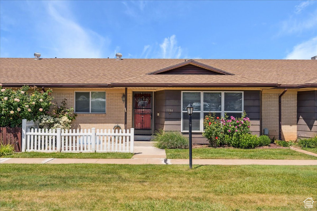 Single story home with brick siding and roof with shingles