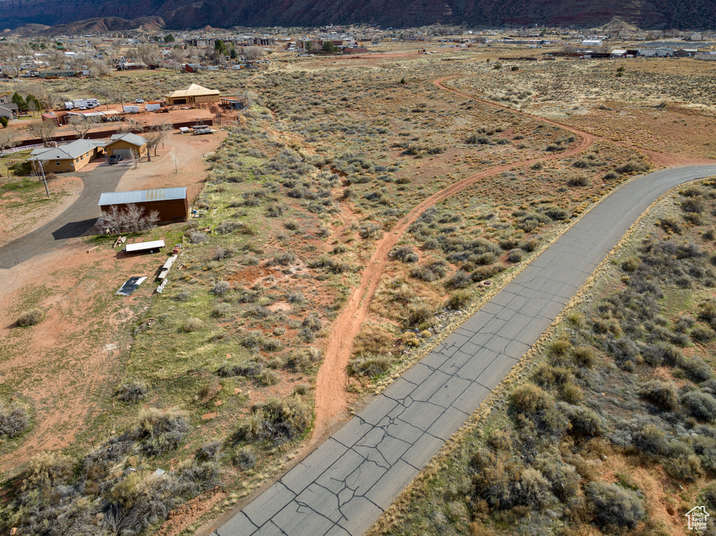 Aerial view of property and surrounding area featuring a mountainous background