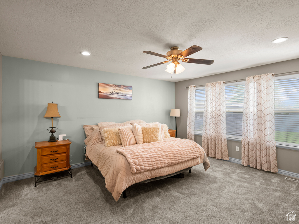 Bedroom with a textured ceiling, carpet, baseboards, ceiling fan, and recessed lighting