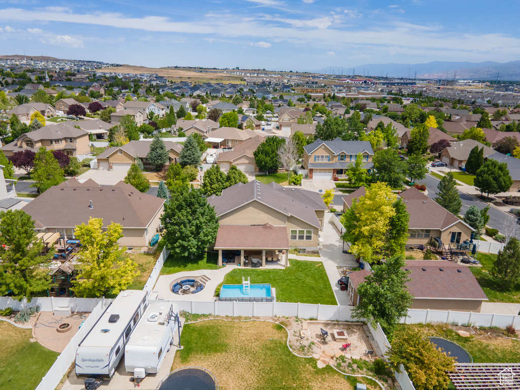 Aerial view of residential area featuring a pool and mountains