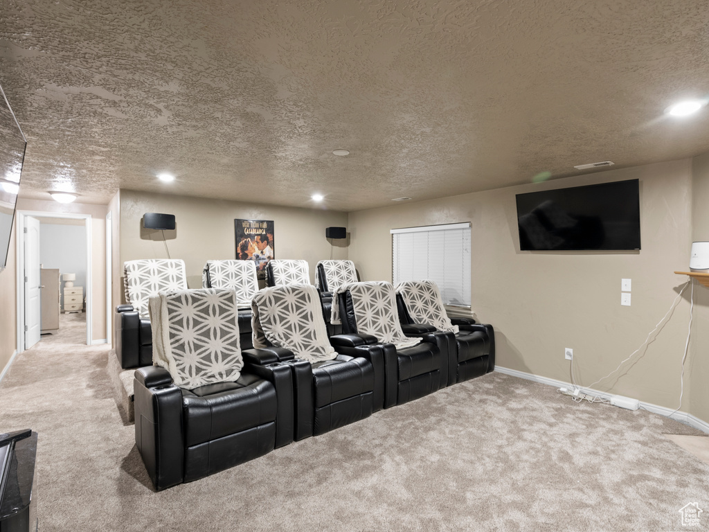 Cinema featuring carpet flooring, baseboards, a textured ceiling, and recessed lighting
