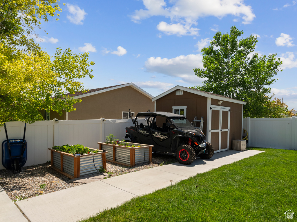 View of shed with a vegetable garden