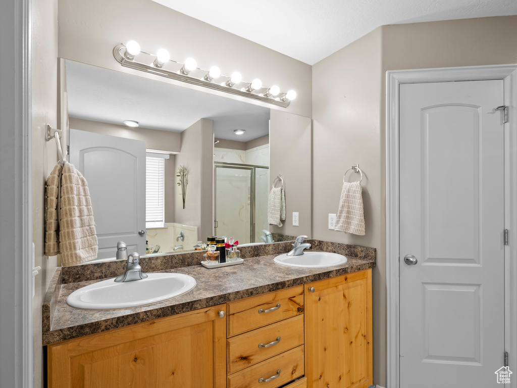 Bathroom with a stall shower and double vanity