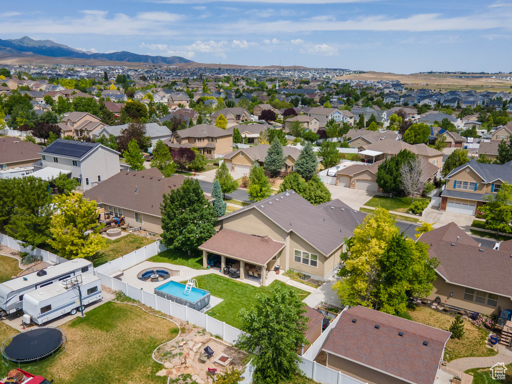 Aerial view of residential area with a pool and a mountain backdrop