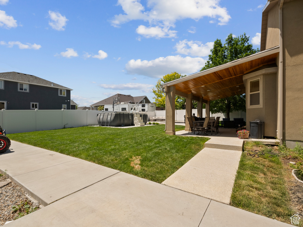 View of yard with a pool and a patio area