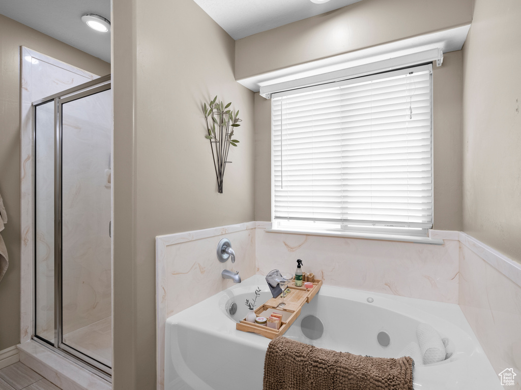 Full bathroom with a shower stall and a bath