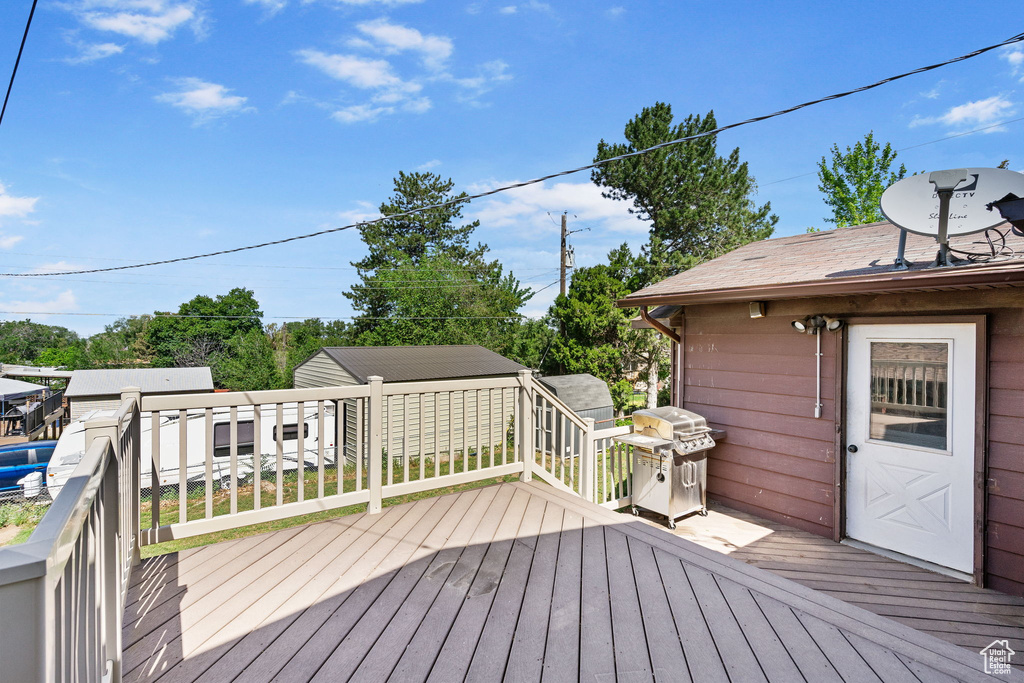Wooden terrace featuring area for grilling