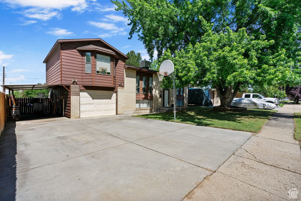 View of front of house with brick siding, driveway, and an attached garage