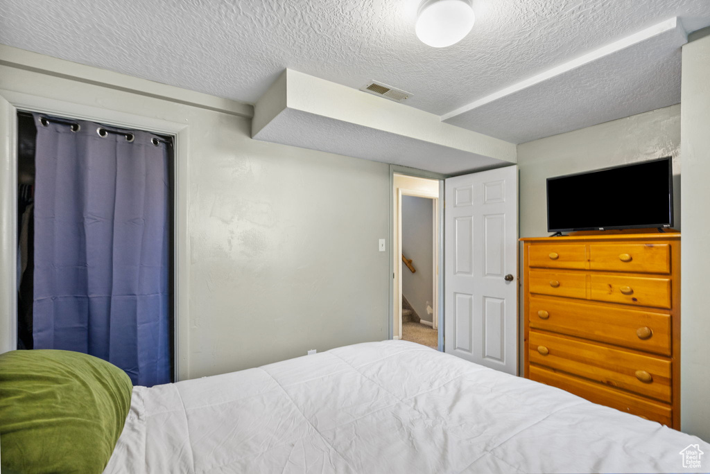 Bedroom with a textured ceiling