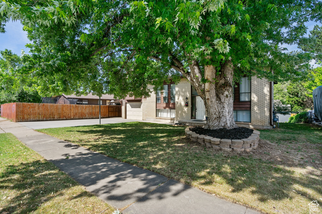 View of front of property with brick siding and a garage