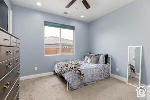 Carpeted bedroom featuring baseboards, a ceiling fan, and recessed lighting