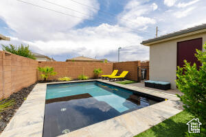 View of pool with a fenced backyard and a patio