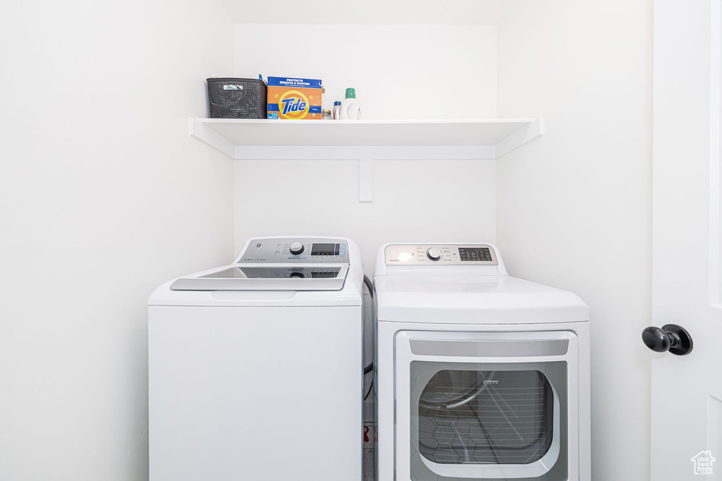 Laundry room with washer and clothes dryer