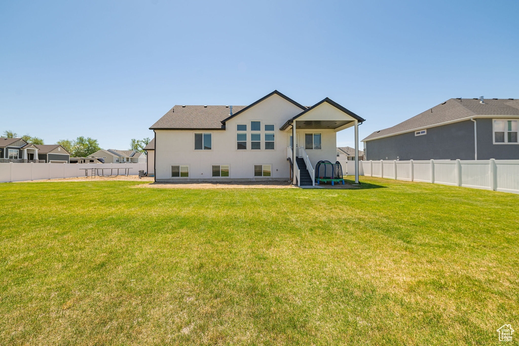 Rear view of property featuring stucco siding