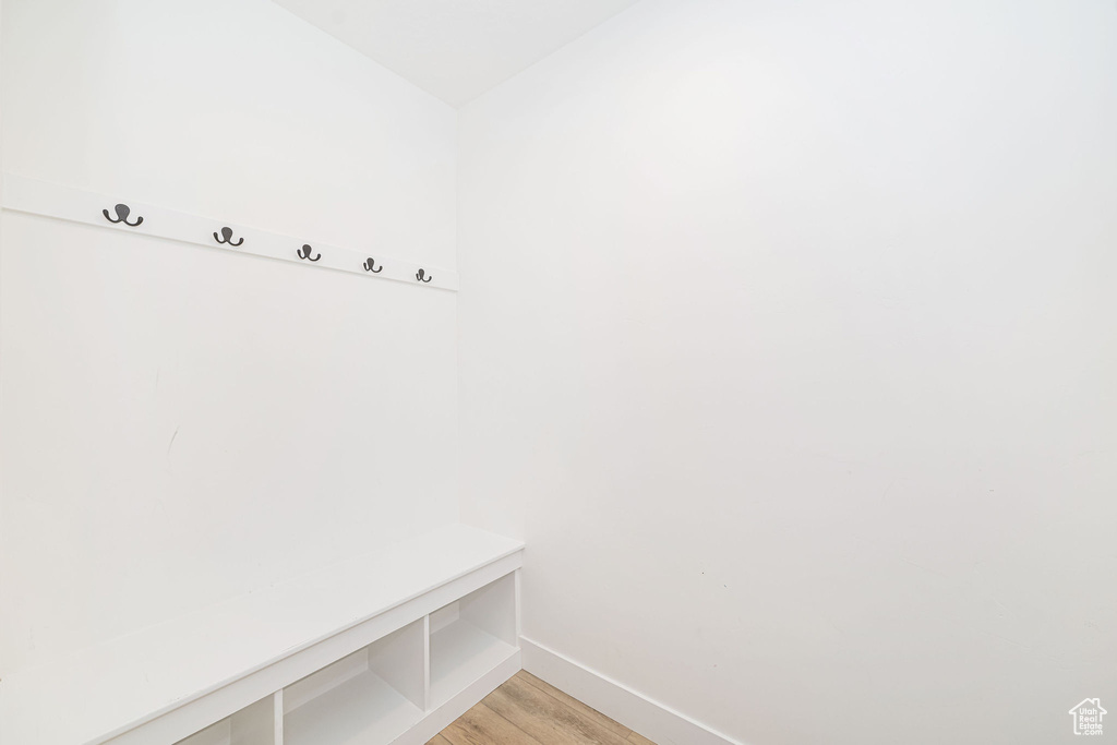 Mudroom with baseboards and light wood-type flooring