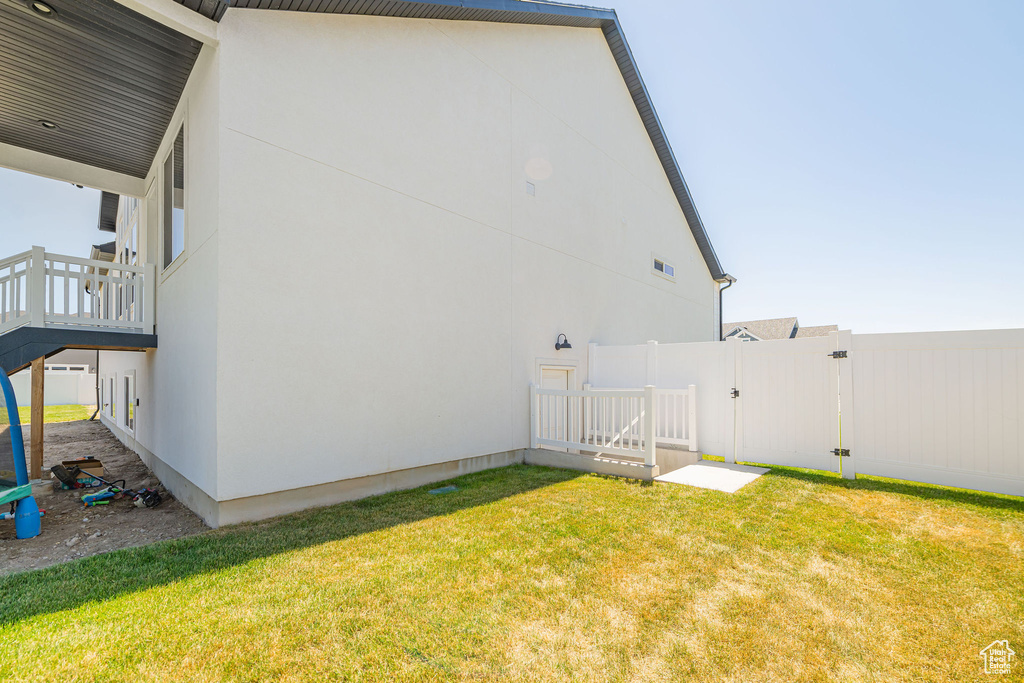View of property exterior featuring a gate and stucco siding
