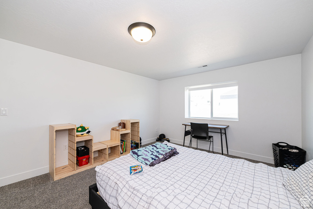 Bedroom featuring baseboards and carpet floors