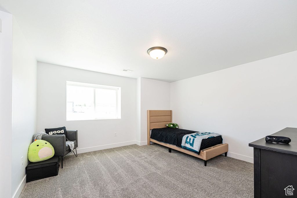 Carpeted bedroom featuring baseboards