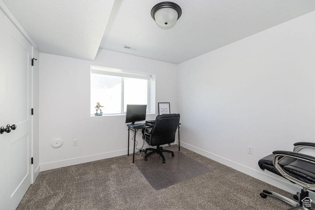 Carpeted office featuring baseboards