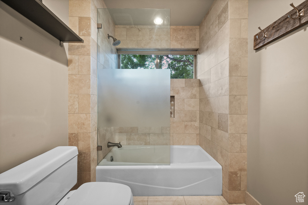 Full bathroom featuring toilet, shower / bathtub combination, and tile patterned floors