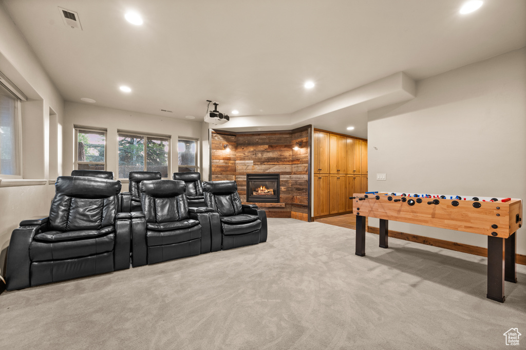 Cinema with a fireplace, recessed lighting, and light carpet