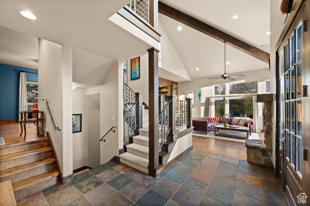 Stairs with stone tile flooring, ceiling fan, baseboards, recessed lighting, and beamed ceiling