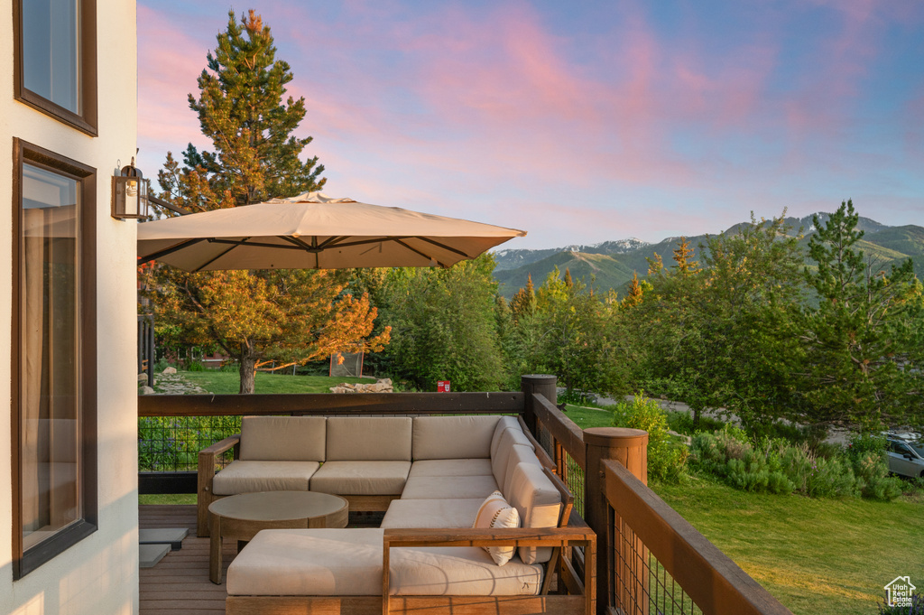 Wooden terrace featuring an outdoor living space and a mountain view