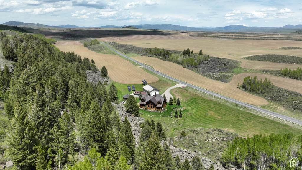 Aerial view of property's location featuring rural landscape and a mountain backdrop
