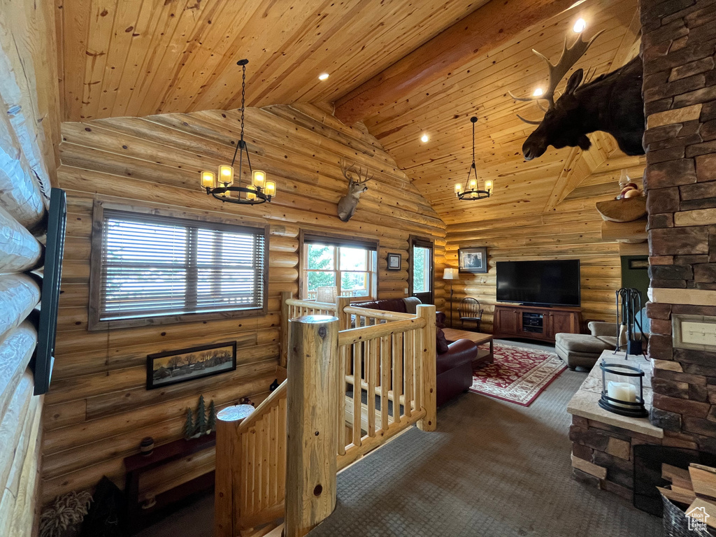 Living area featuring a chandelier, rustic walls, wood ceiling, high vaulted ceiling, and carpet
