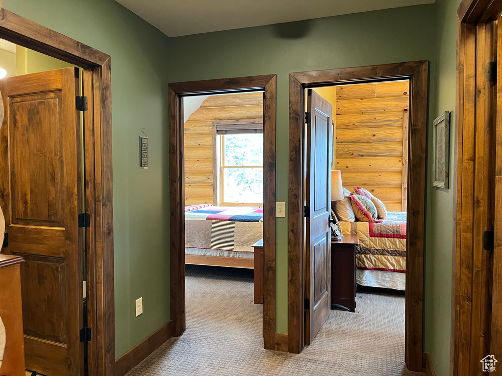 Hallway featuring carpet flooring and baseboards