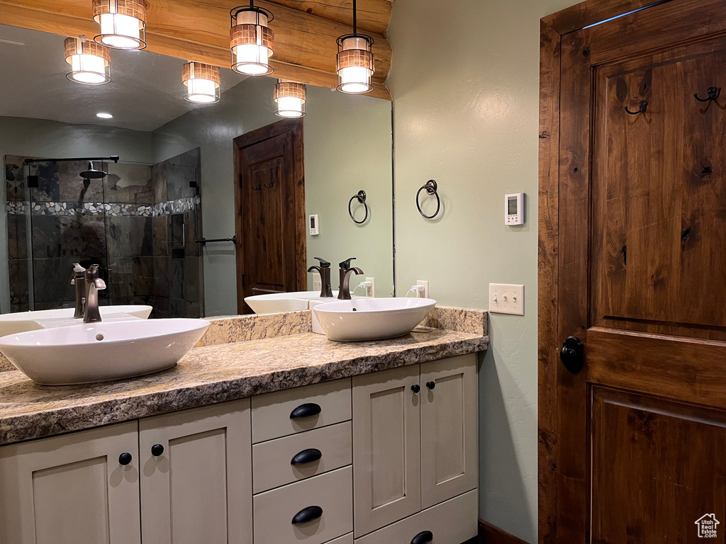 Bathroom with double vanity and a tile shower