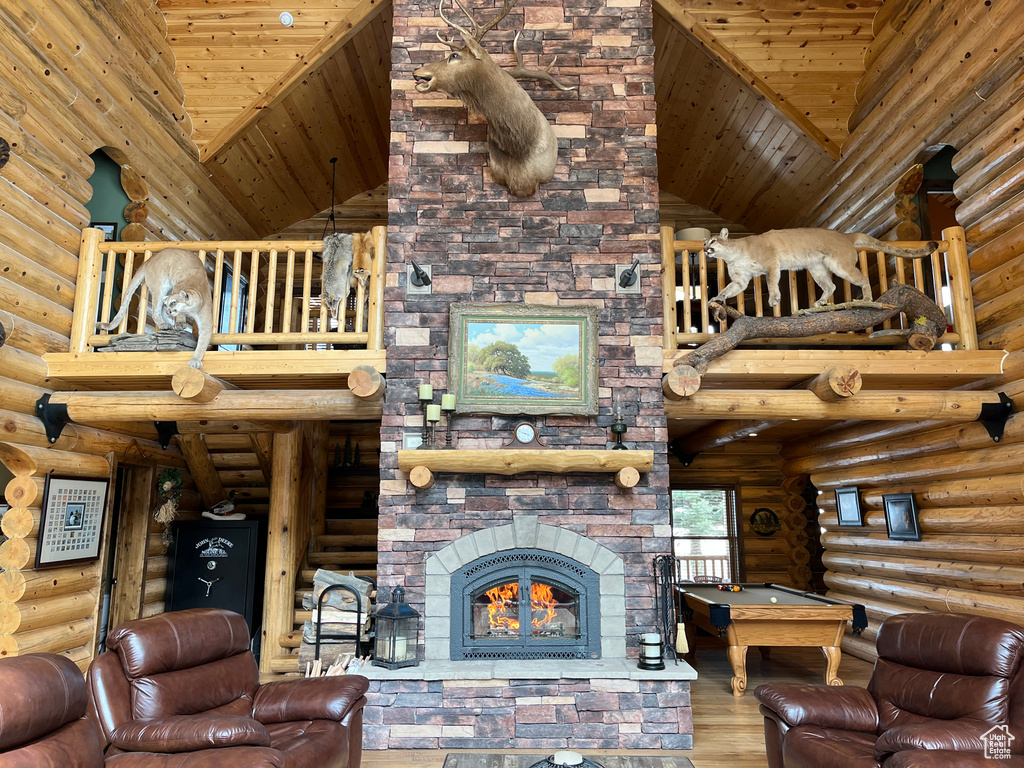 Living room featuring log walls, high vaulted ceiling, wood finished floors, pool table, and wooden ceiling