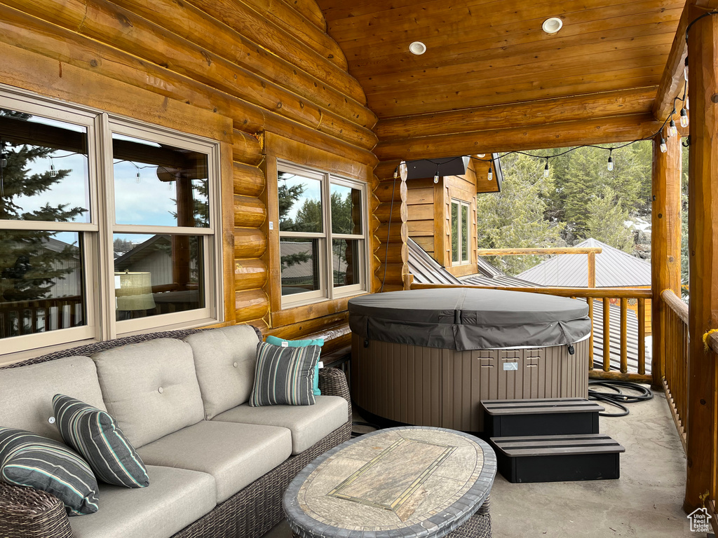 View of patio featuring a hot tub and outdoor lounge area
