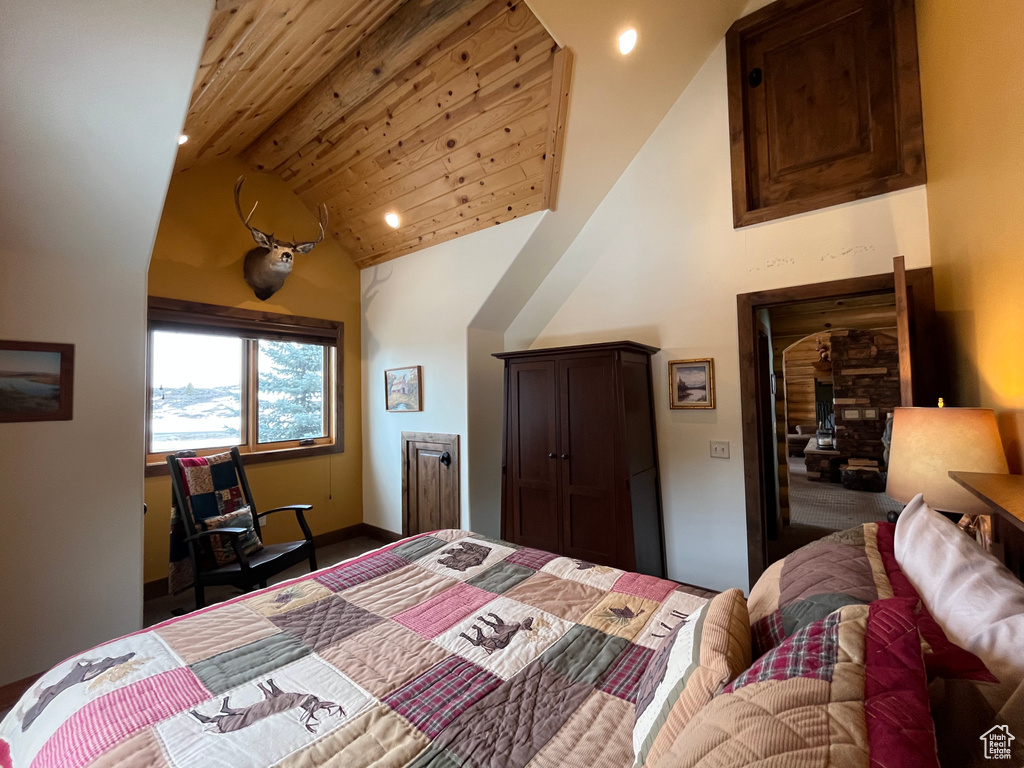 Bedroom featuring high vaulted ceiling, recessed lighting, and baseboards
