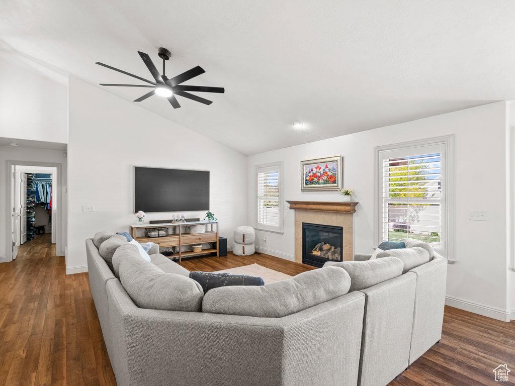 Living room featuring a ceiling fan, dark wood finished floors, baseboards, healthy amount of natural light, and high vaulted ceiling